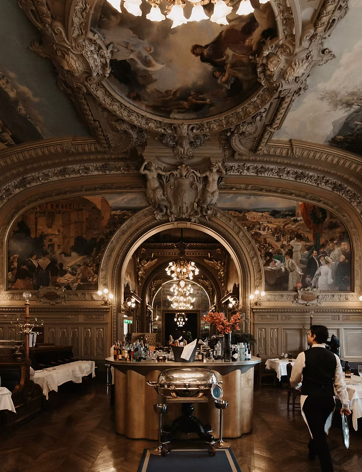 An ornate dining room laid for the evening