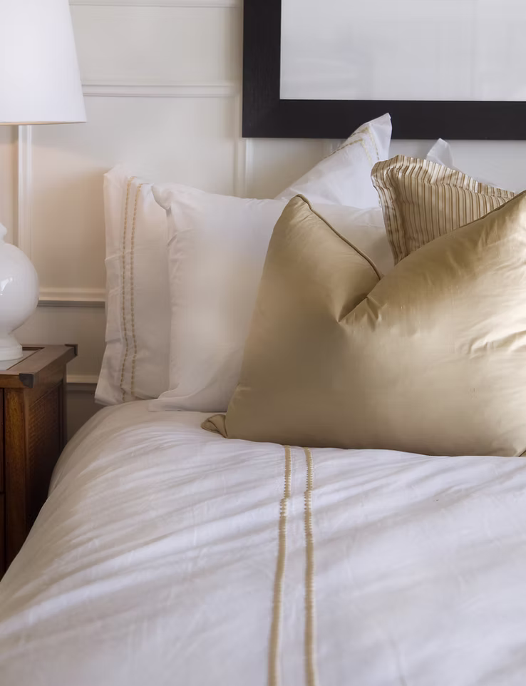 Hotel bed made up in white and gold