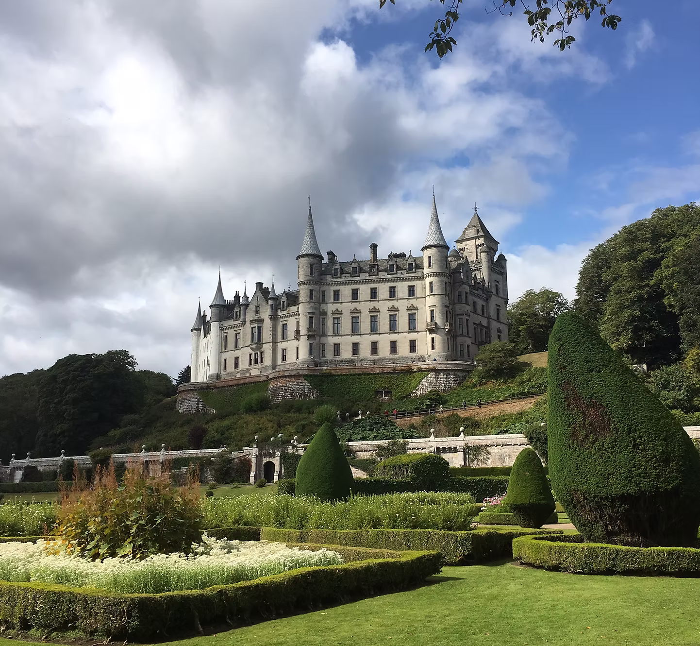 A castle above its formal gardens on the Scottish coast