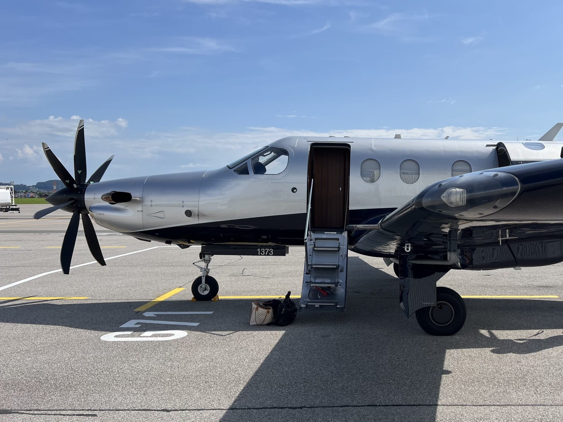 A Pilatus PC-12 on the apron with its airstair extended