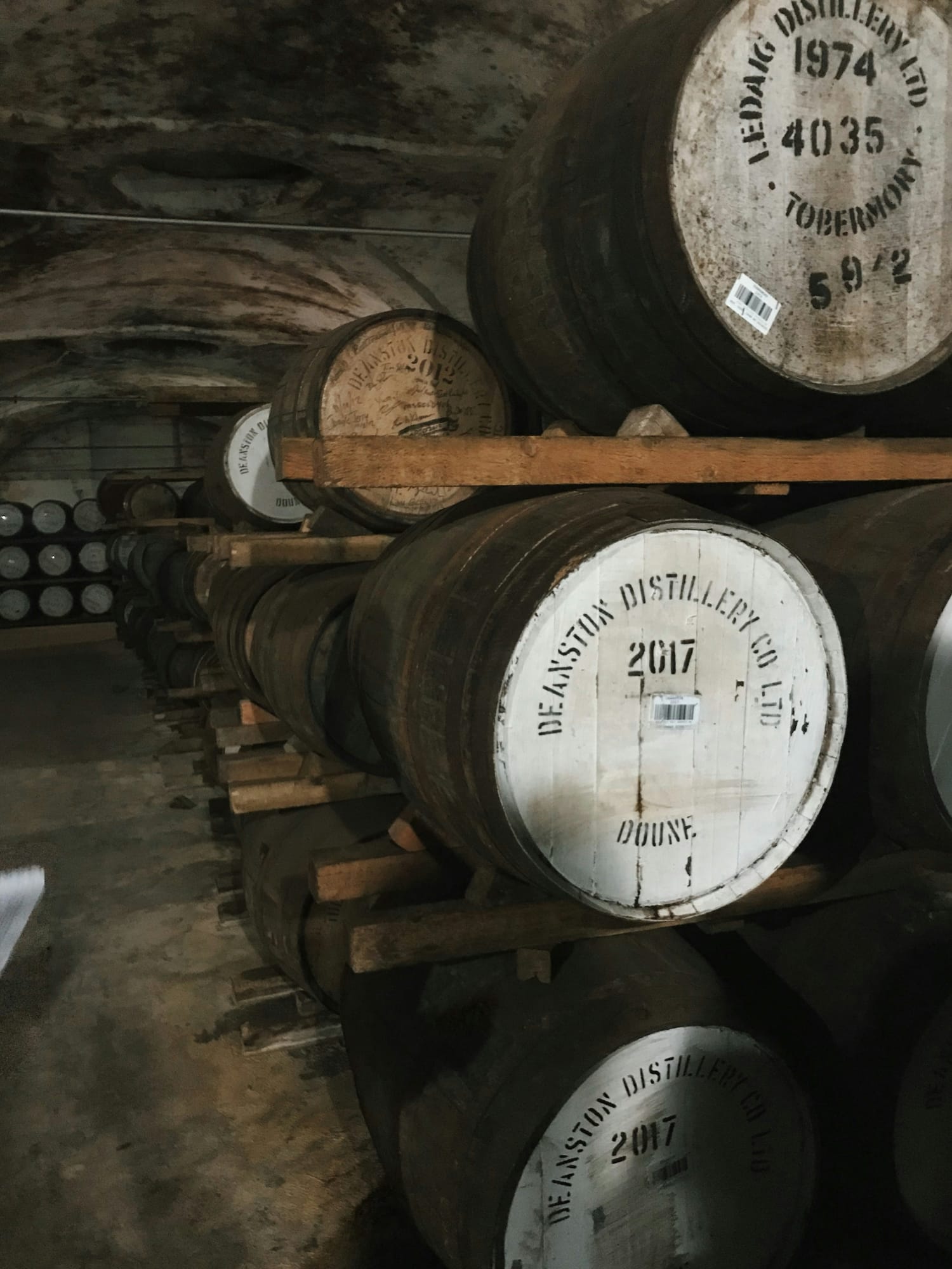Whisky casks maturing in a distillery warehouse