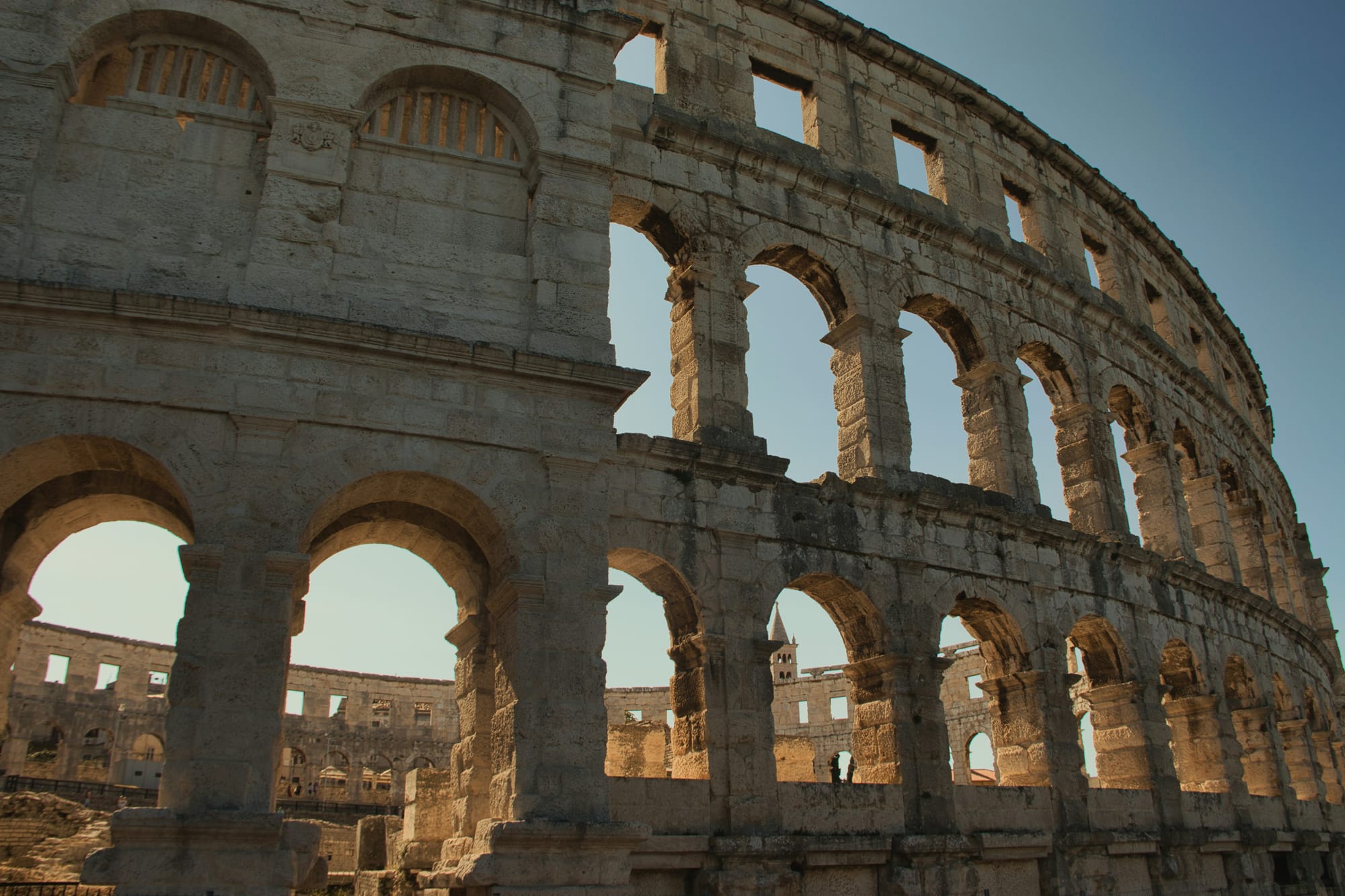 The arches of the Roman amphitheatre in Pula in the evening light